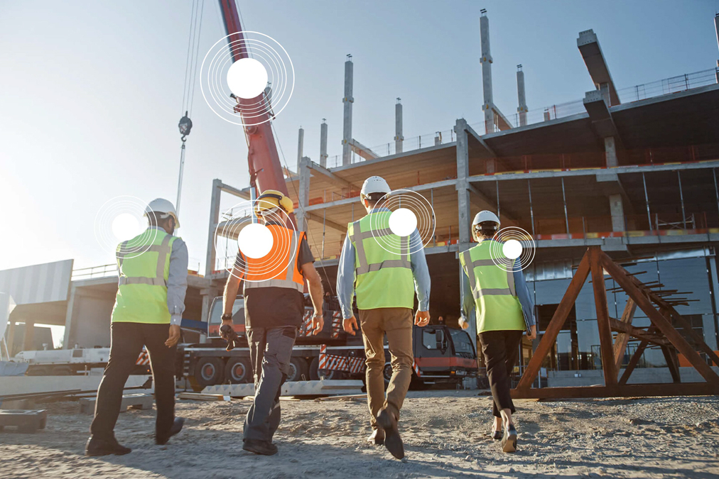 A picture of construction workers wearing the TokenMe wearable technology on the jobsite Image Source: TokenMe