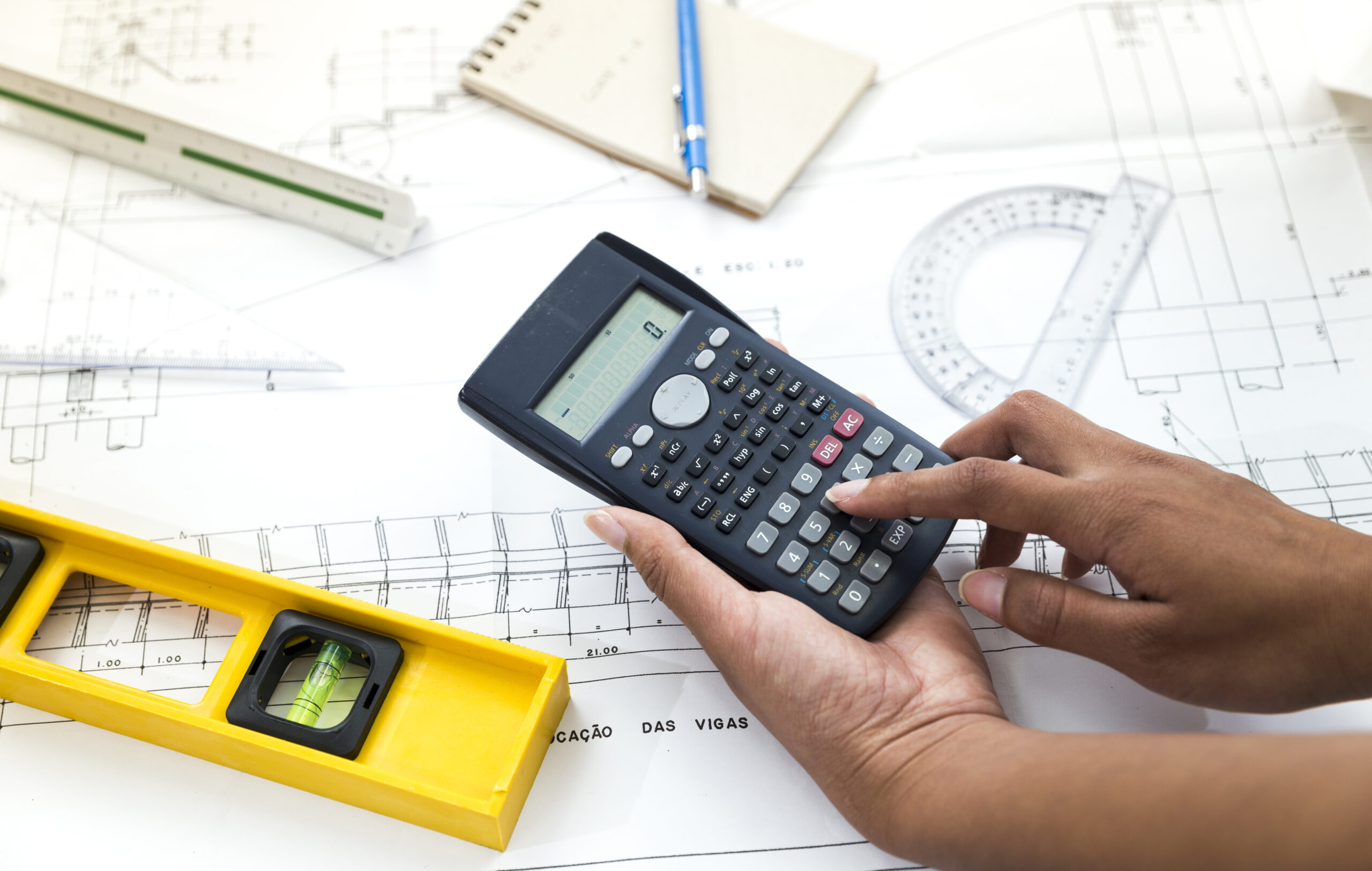 woman-using-calculator-near-plan-equipments-07