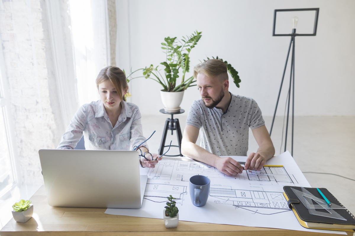 young-man-looking-laptop-by-using- construction-software-in-workplace