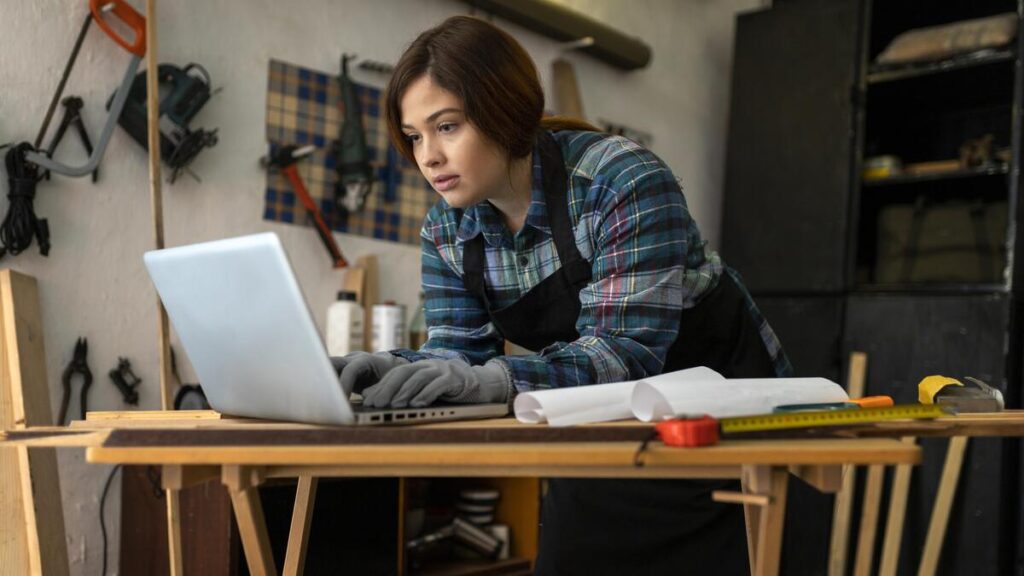 female-workshop-checking-accounting-software-on-laptop