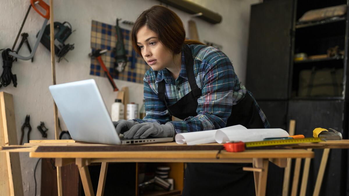 female-workshop-checking-accounting-software-on-laptop