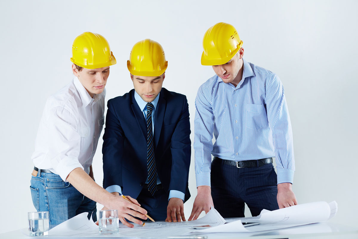 engineers-with-helmets-reviewing-risk-management-strategies