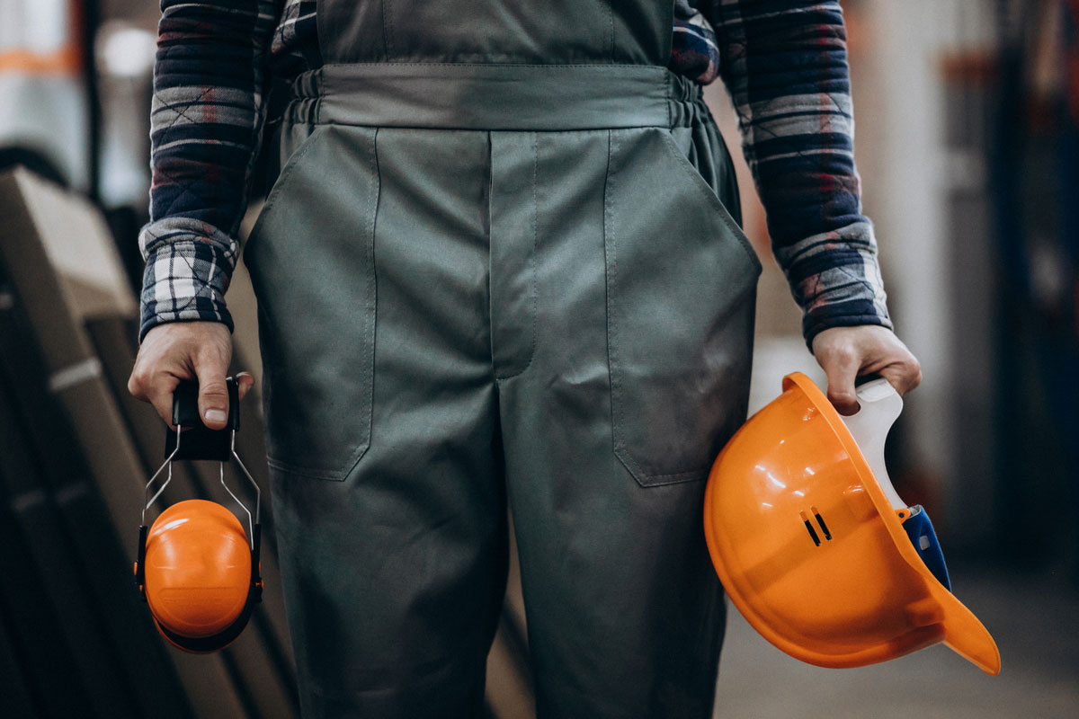 young-male-handyman-with-safety-earphones-Construction-Statistics