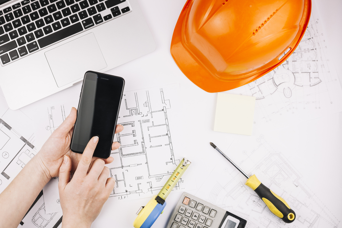 Engineer-Working-with-Construction-Management-Software-on-the-phone