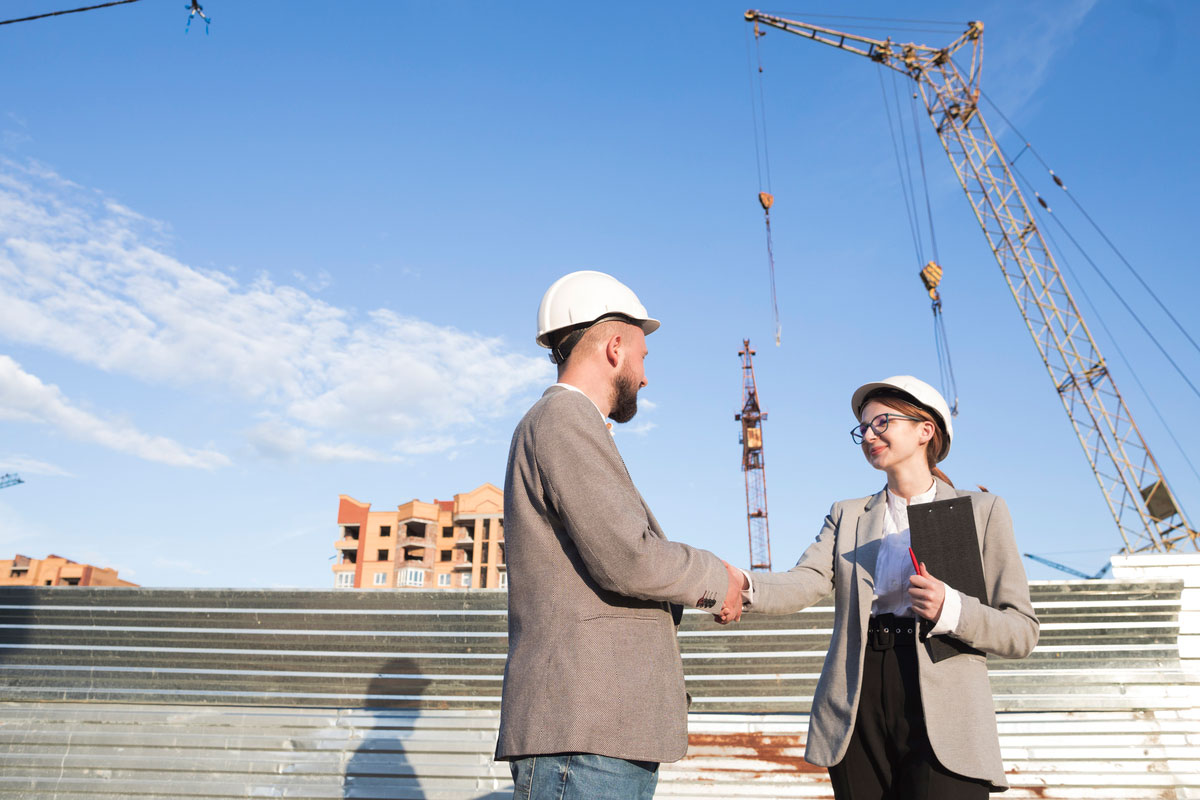 two-professional-engineer-shaking-hand-construction-site-about-change-order-in-construction