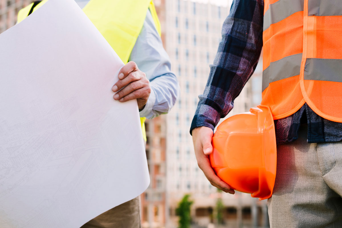 Construction-Site-Safety-close-up-men-with-safety-vests-helmet