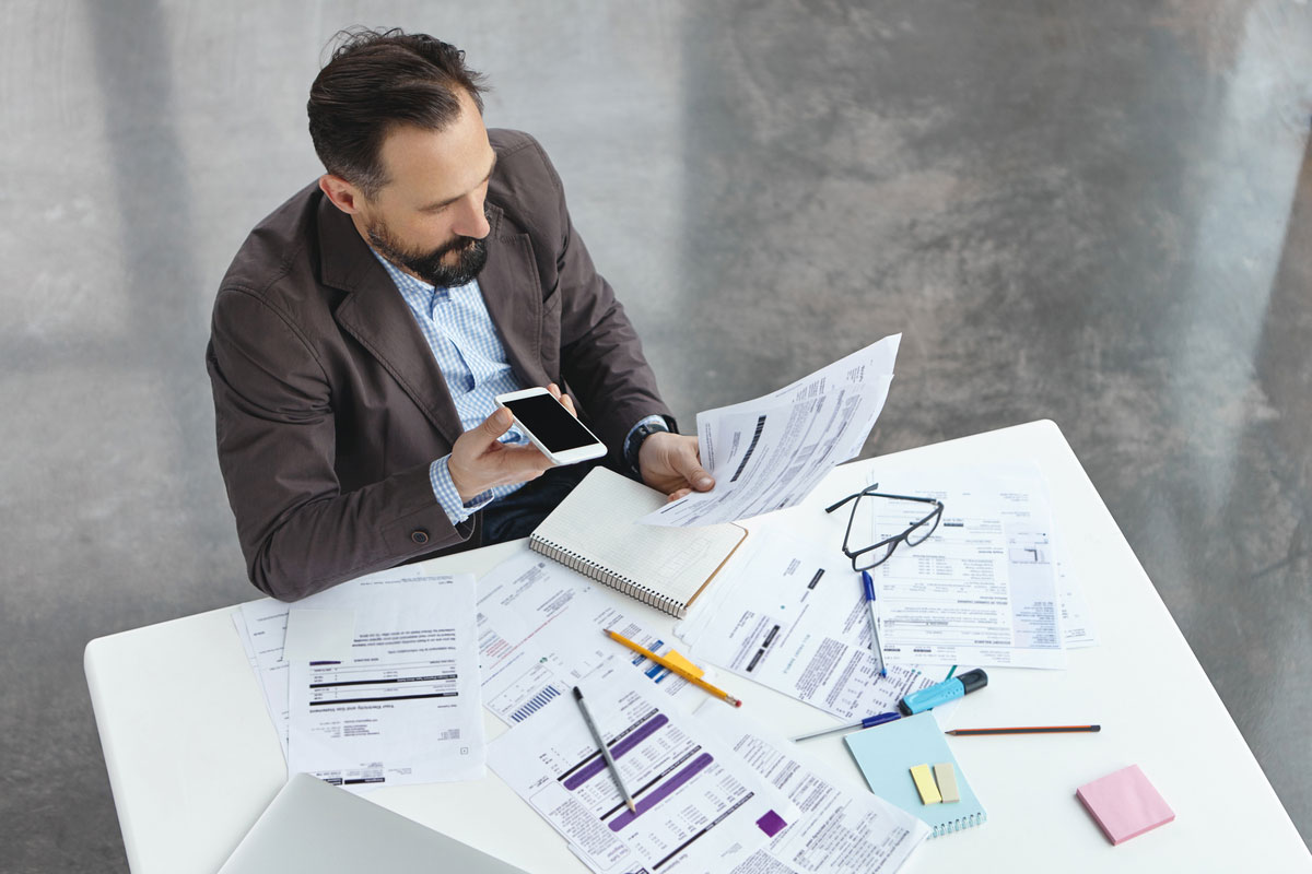 businessman-office-talking-phone-planning-construction-takeoff