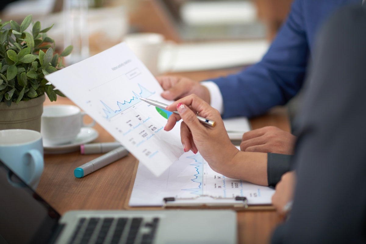 hands-man-woman-business-attire-sitting-desk-office-discussing-graph-risk-management-plan