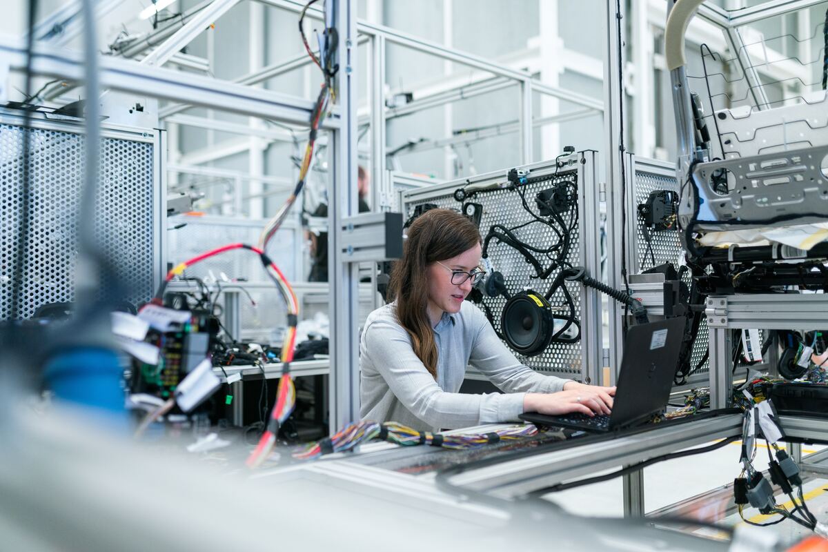 Woman-in-White-Long-Sleeve-Shirt-Using-Black-Laptop-Computer-Industrial-Internet-of-Things