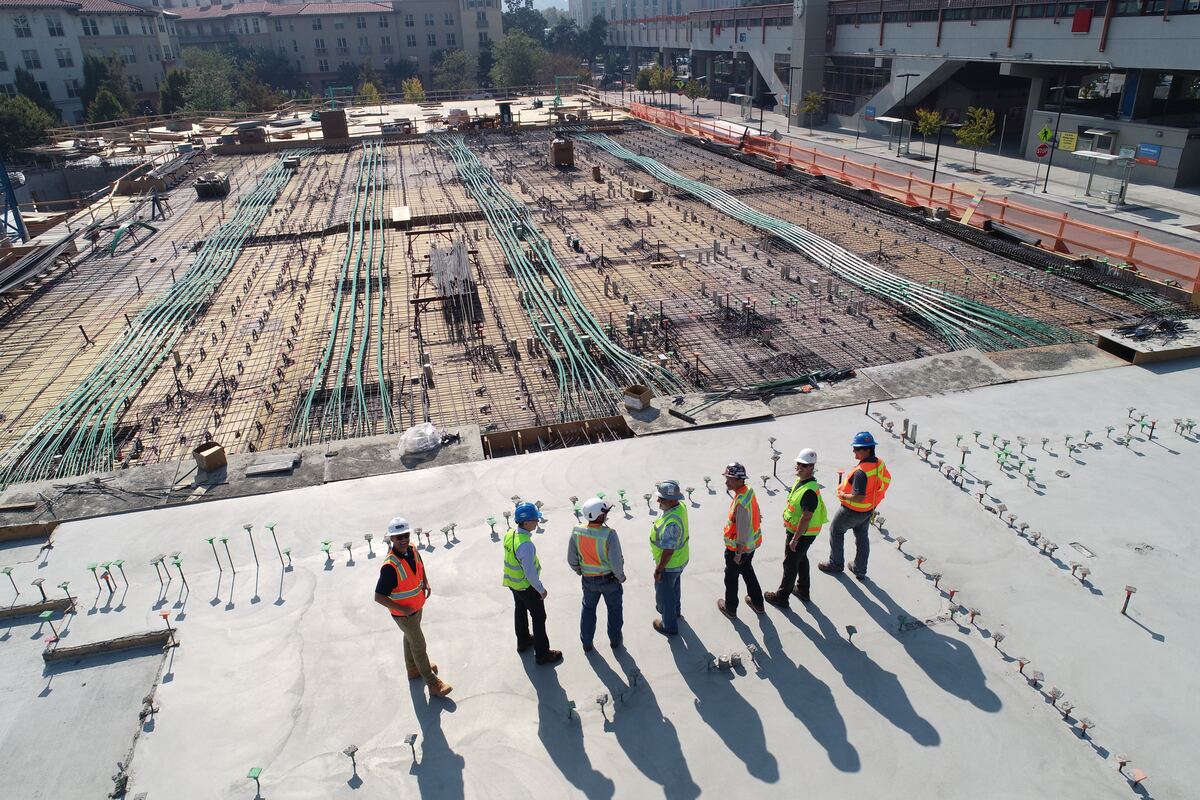 Seven-Construction-Workers-Standing-On-White-Field-Construction-Scheduling