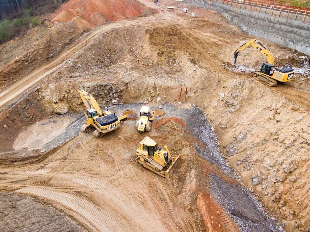 Top-View-The-Photography-of-Four-Heavy-Equipment-on-Quarry-During-Daytime-Construction-Materials