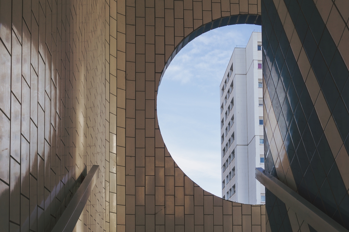 white-building-visible-from-round-window-tiled-building-rendered-on-architectural-rendering-software