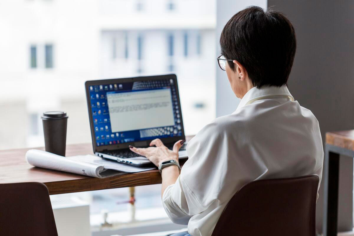 short-haired-business-woman-working-her-computer-Building-Management-System