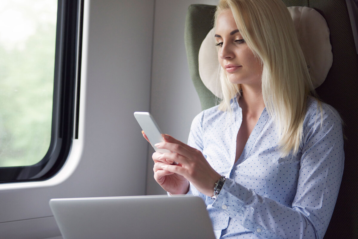 Businesswoman-Working-By-Mobile-Devices-During-Travel-IoT in-Railway