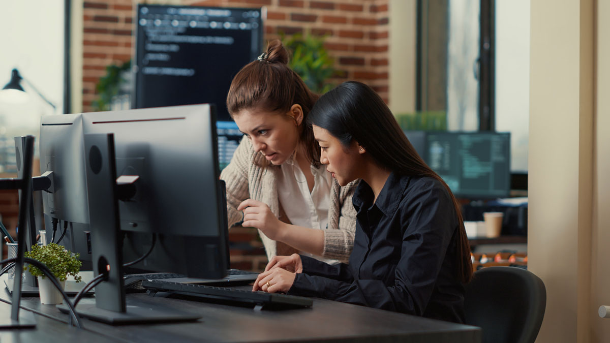 team-coworkers-comparing-source-codes-running-laptop-screen-computer-monitor-it-development-office-Construction-Digital-Handover