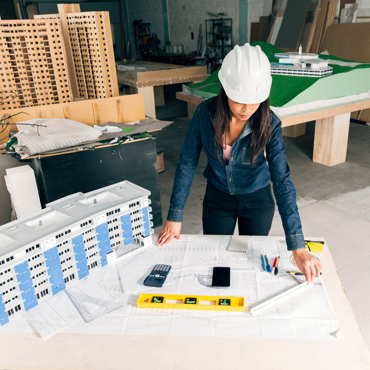 african-american-lady-safety-helmet-standing-near-model-Live-Building-Systems