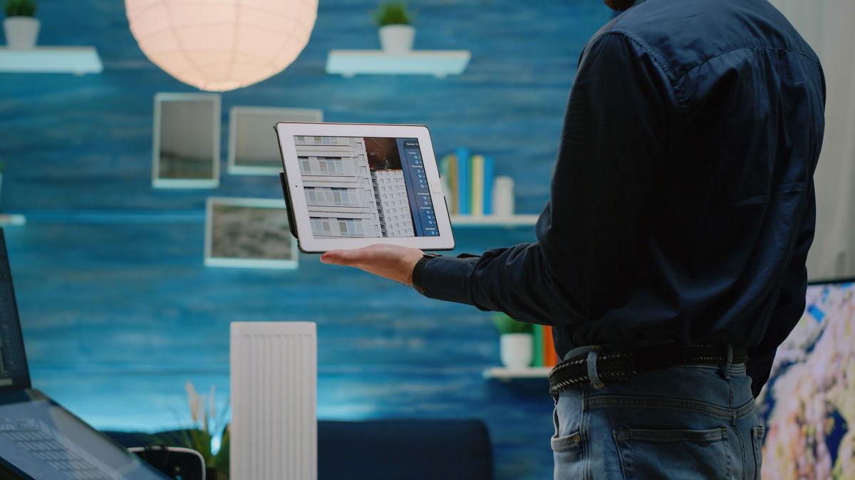close-up-architect-using-tablet-with-touch-screen-analyze-building-model-architectural-development-man-engineer-working-with-device-construction-layout-design-Scan-to-BIM-Benefits