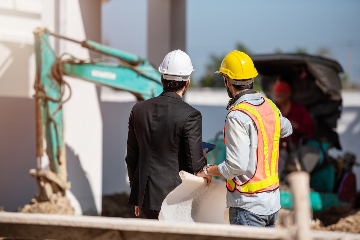 Construction-Worker-and-Engineer-Working-Together-on-Construction-Site-Submittal-in-Construction