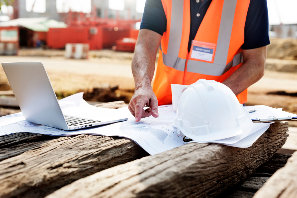 Closeup-Contractor-Construction-Site-Pointing-Plan-Wooden-Sleeper-Construction-Document-Management