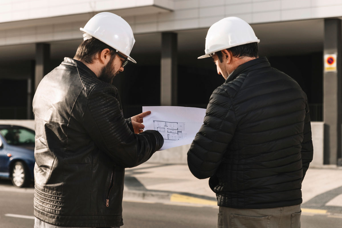 Men-Helmets-Looking-Plans-Construction-Document-Management