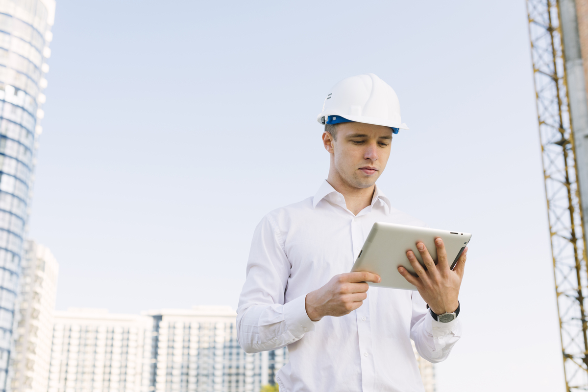 medium-shot-young-man-with-helmet-tablet-Digitalization-in-the-Construction-Industry