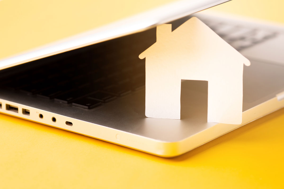 Close-Up-House-Figure-With-Laptop-IoT-in-Insurance