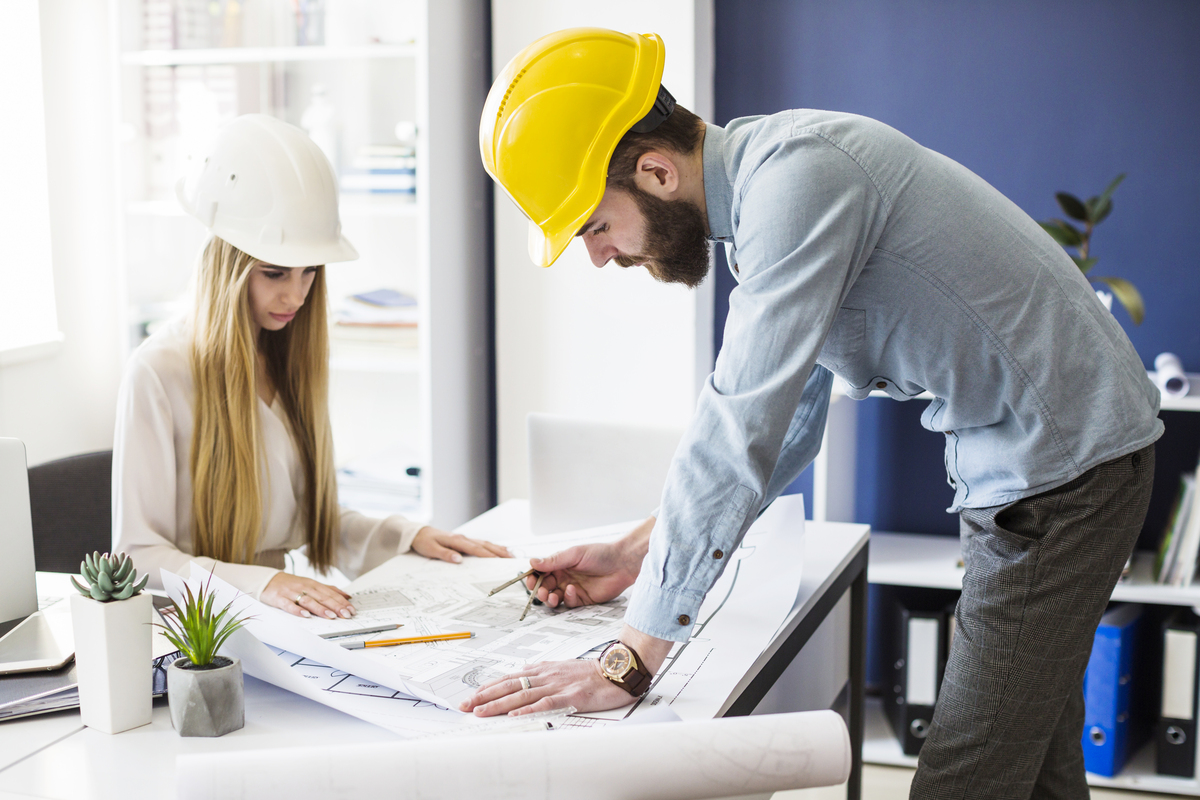 male-engineer-drawing-plan-blue-print-with-architect-equipment-Preliminaries-in-Construction