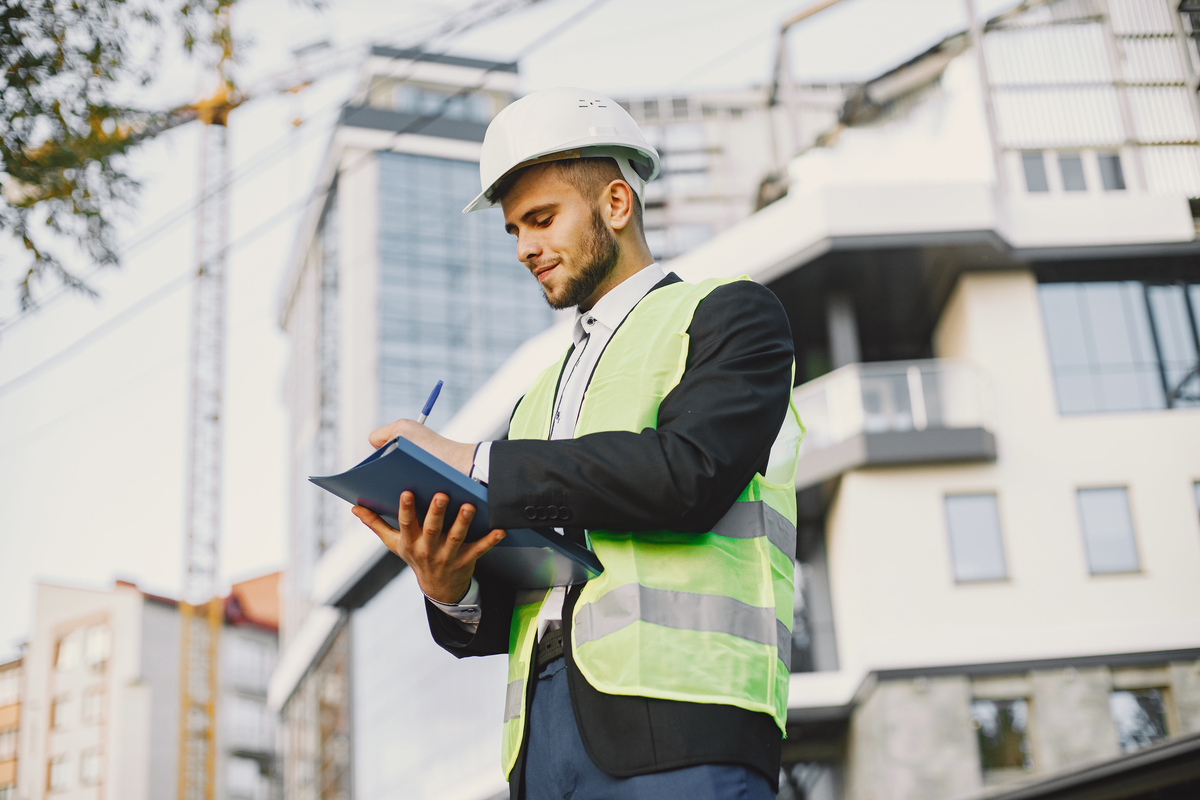 man-builder-uniform-holding-older-looking-building-plan-construction-reporting