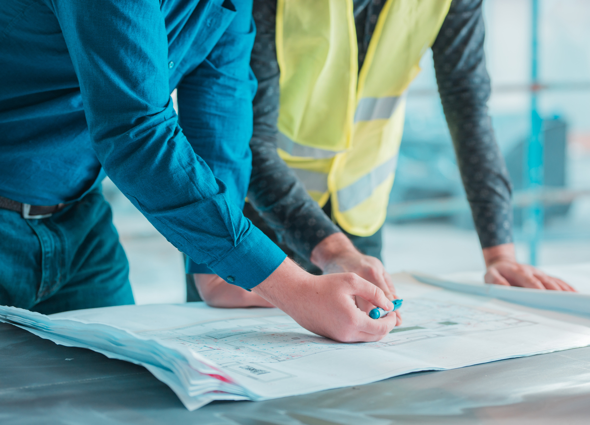 workers-checking-out-architectural-plan-project-construction-reporting