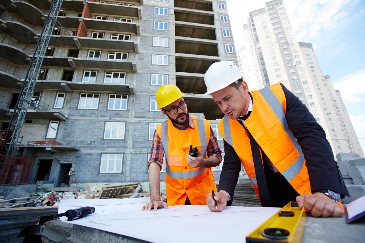 Construction-Terms-and-Definitions-engineers-discussing-blueprints