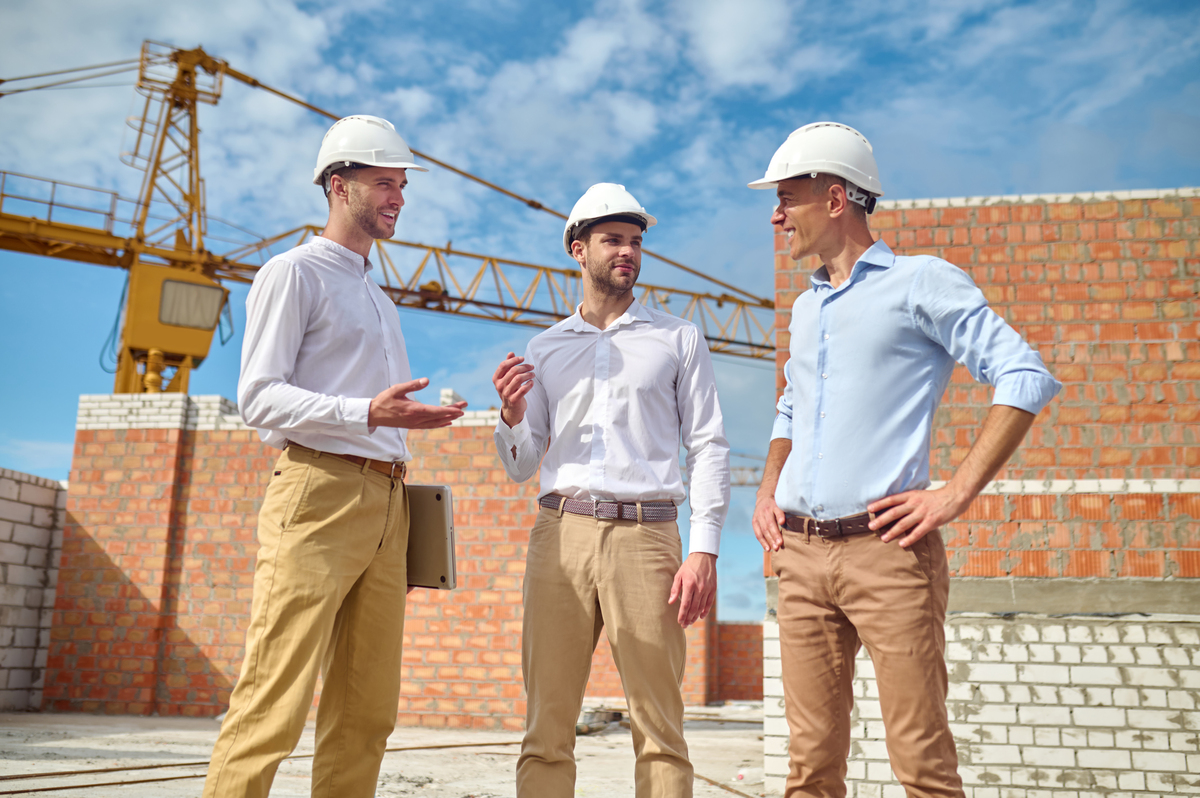 three-men-communicating-construction-site-Construction-Company-in-Dubai