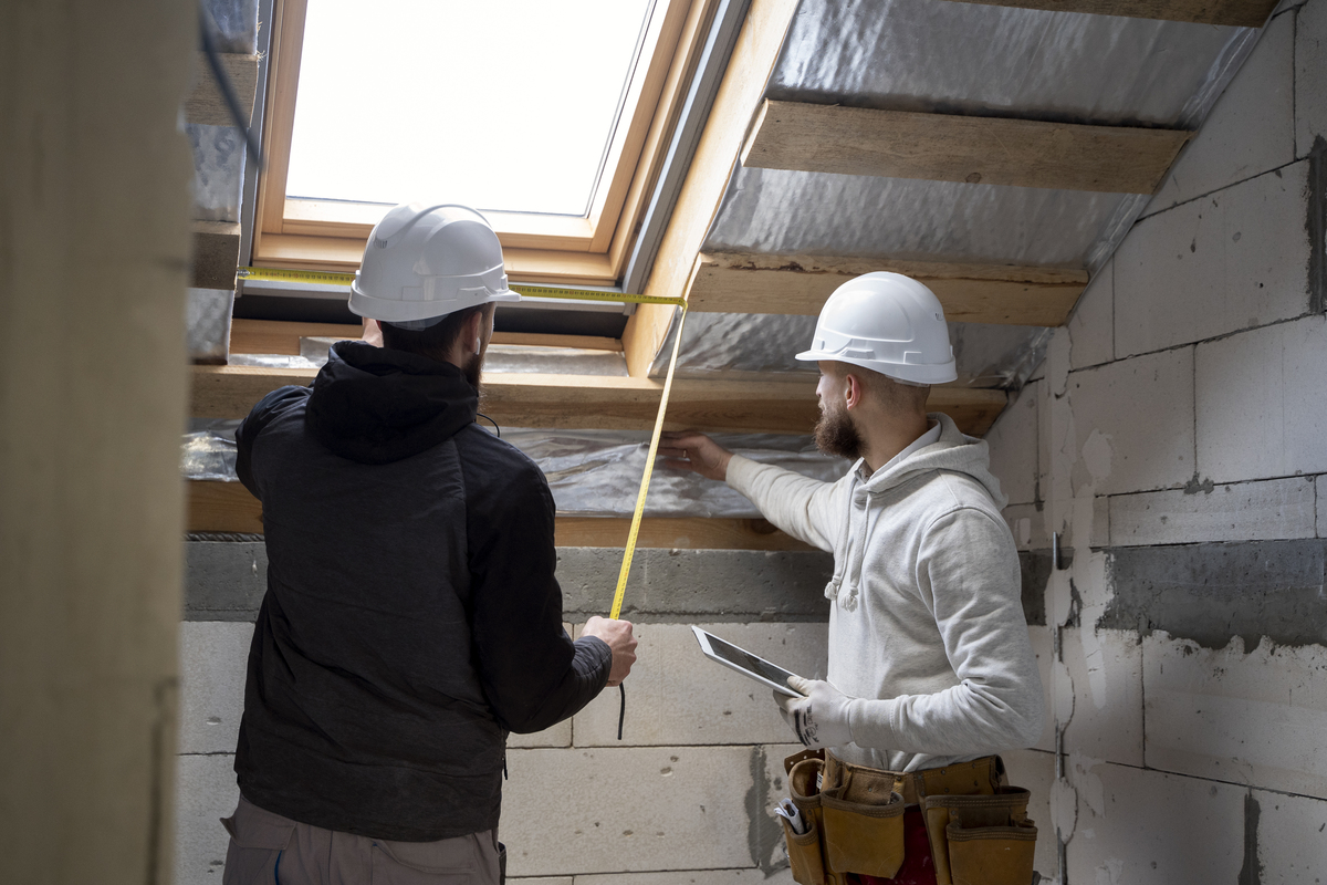 medium-shot-people-working-with-helmets-Construction-Rework