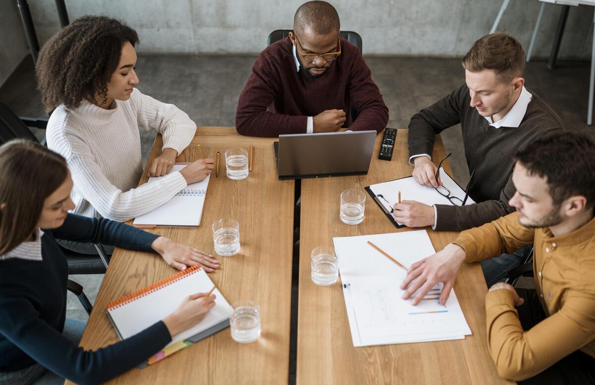 high-angle-people-table-office-during-meeting-Change-Management-Strategies