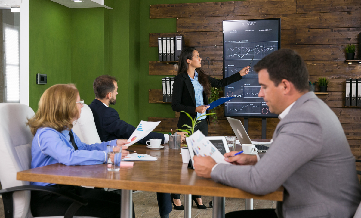 businessman-suit-listening-her-colleague-presenting-charts-tv-screen-conference-room-Change-Management-Examples