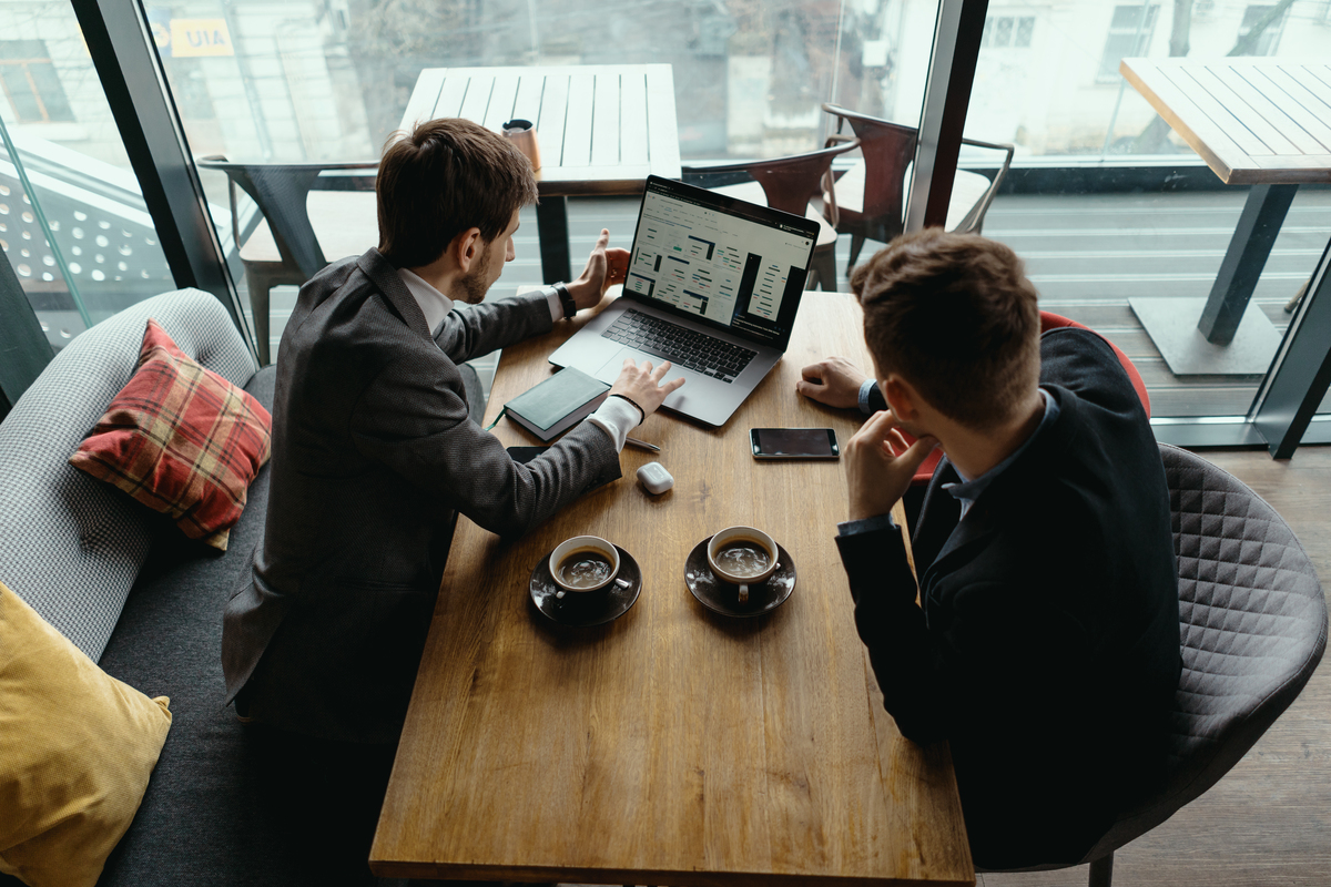  two-young-businessman-having-successful-meeting-restaurant-Change-Management-in-Digital-Transformation