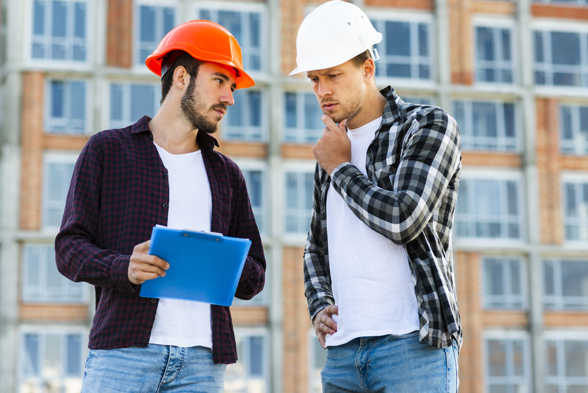 medium-shot-engineer-construction-worker-talking-Construction-Disputes