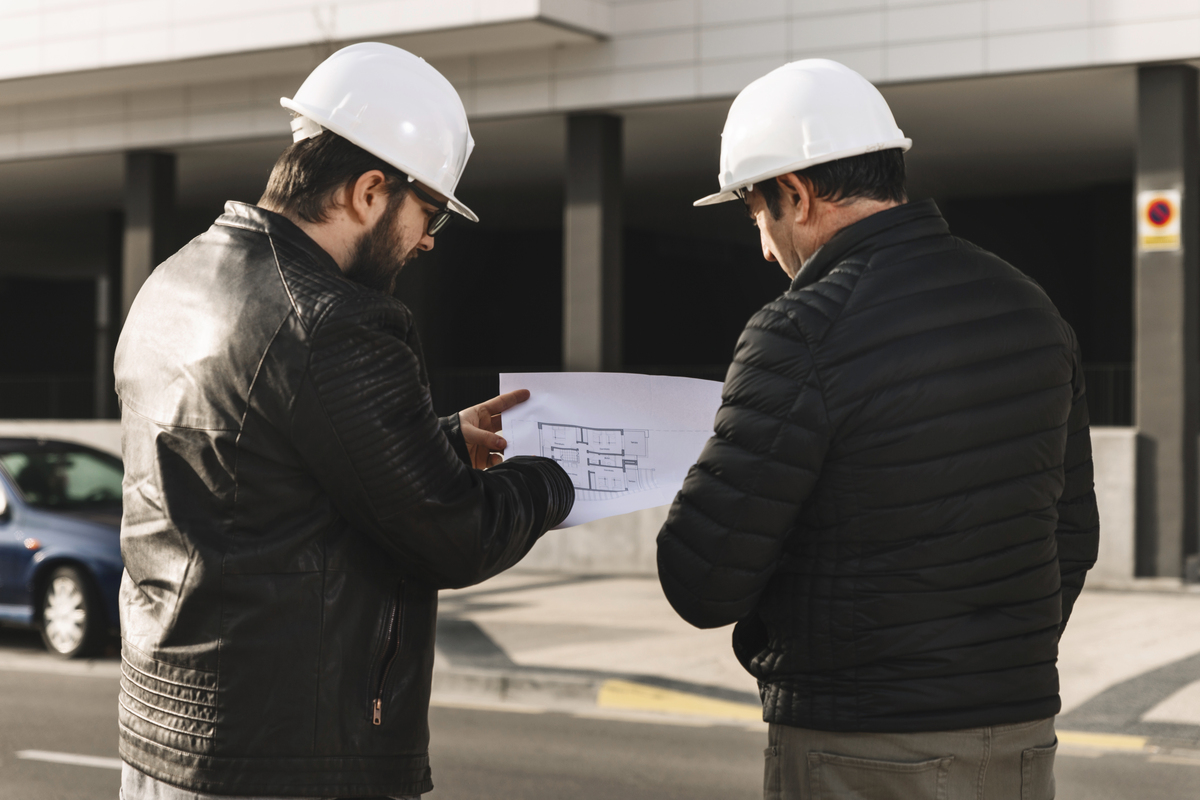 men-helmets-looking-plans-Construction-Disputes