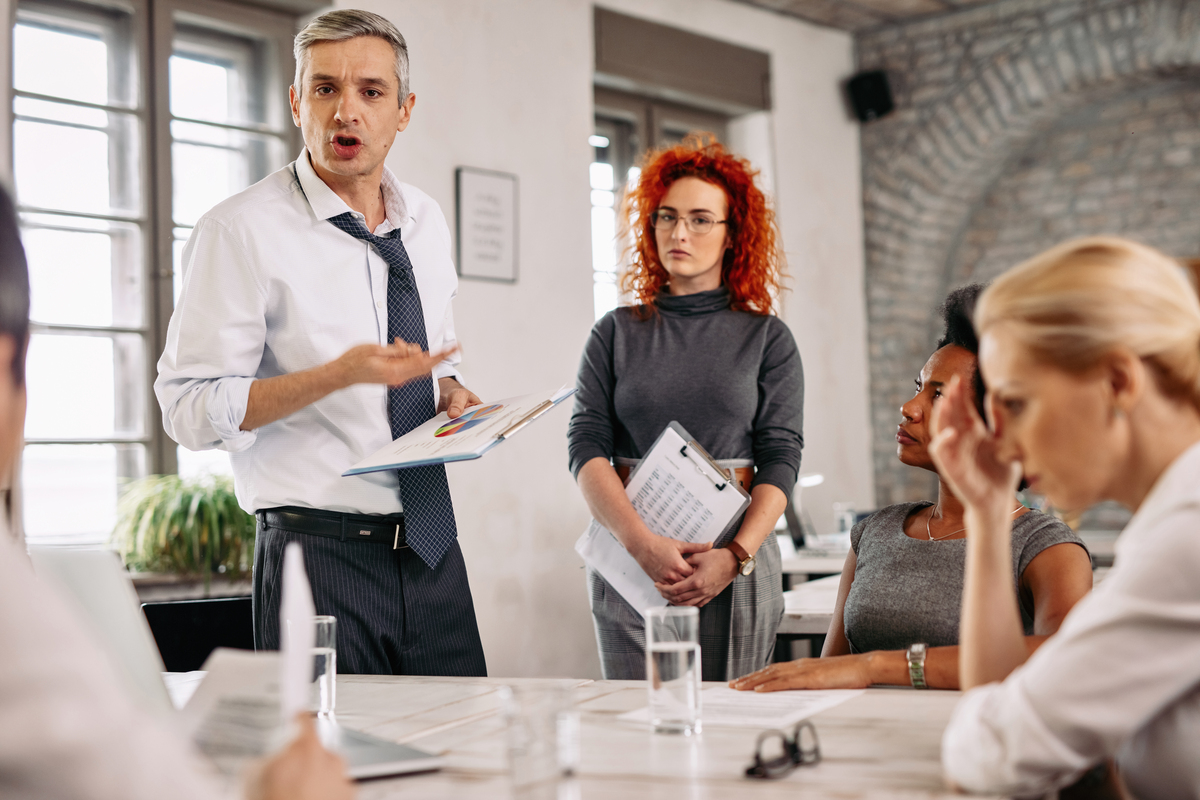 angry-businessman-feeling-disappointed-with-business-reports-scolding-his-team-during-meeting-office-Construction-Disputes