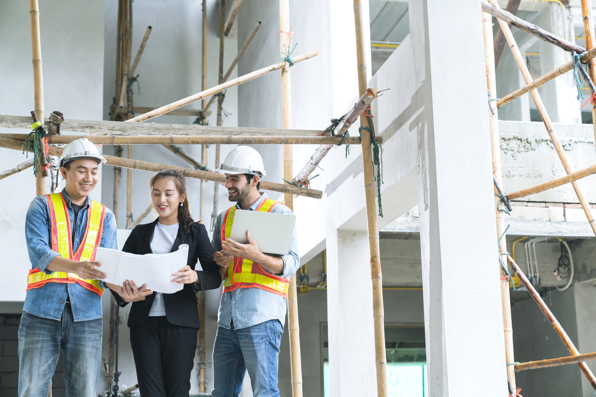 young-asian-engineers-teamwork-site-inspector-discuss-together-using-notebook-computer-paper-blueprint-building-construction-sitehome-renovation-ideas-concept-Lean-Manufacturing