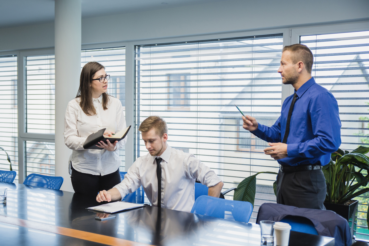 man-talking-coworkers-office-Organizational-Change-Management