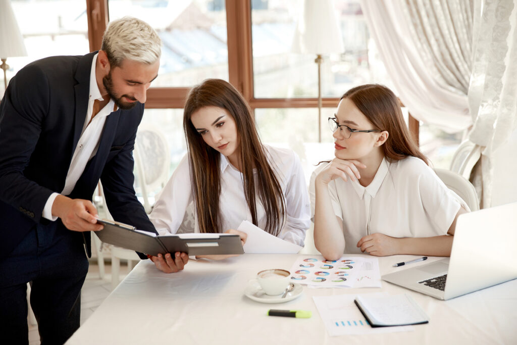 young-coworkers-are-discussing-annual-financial-reports-diagrams-Organizational-Change-Management