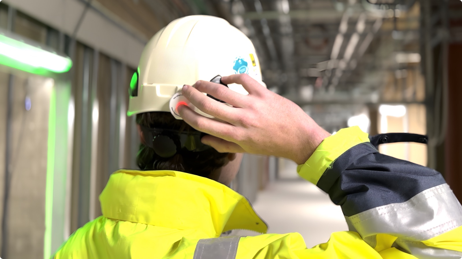 Worker wearing safety device on helmet, New OUH